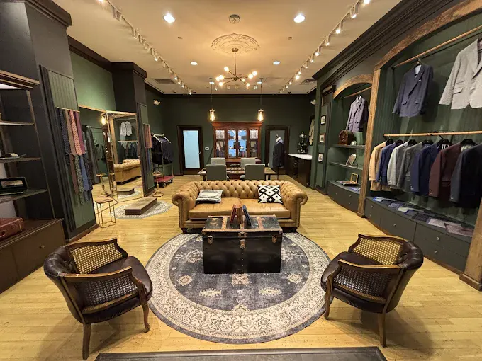 Elegant boutique interior with clothing displays and seating area.